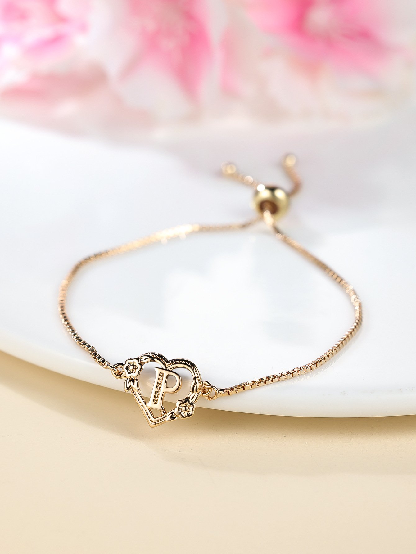 the new adjustable letter bracelet with a heart shaped flower design is a simple and fashionable jewelry the new adjustable letter bracelet with a heart shaped flower design is a simple and fashionable jewelry