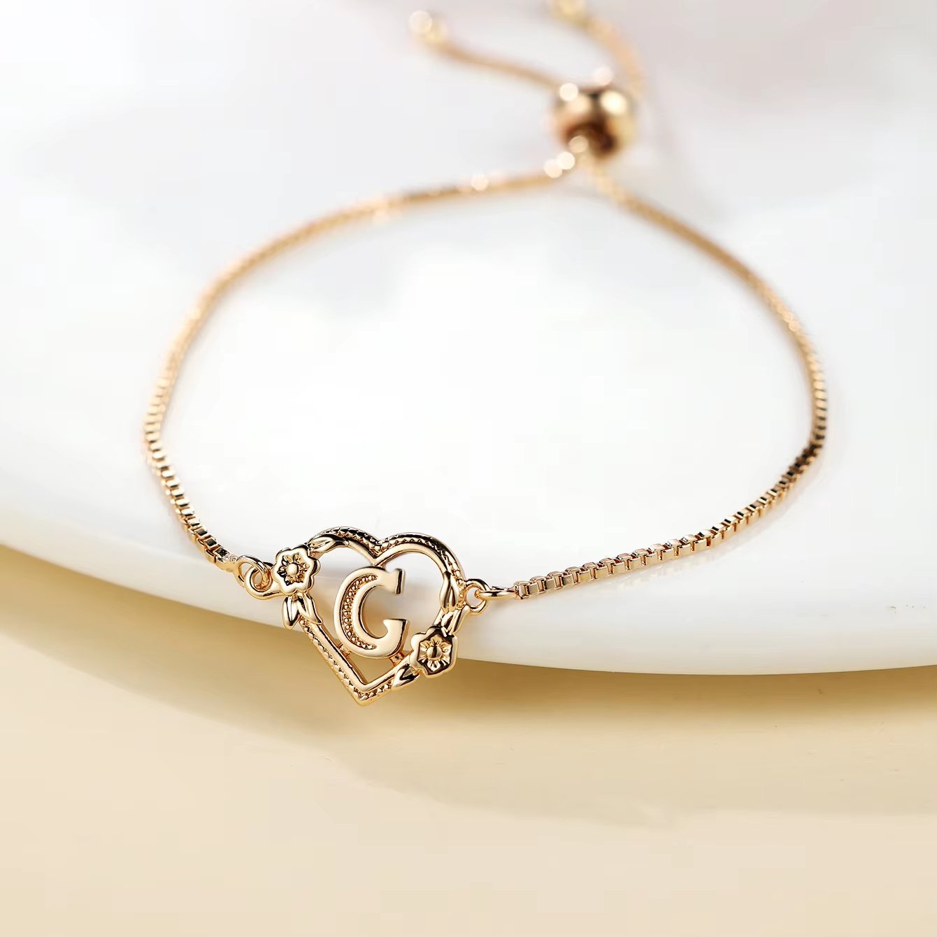 the new adjustable letter bracelet with a heart shaped flower design is a simple and fashionable jewelry the new adjustable letter bracelet with a heart shaped flower design is a simple and fashionable jewelry