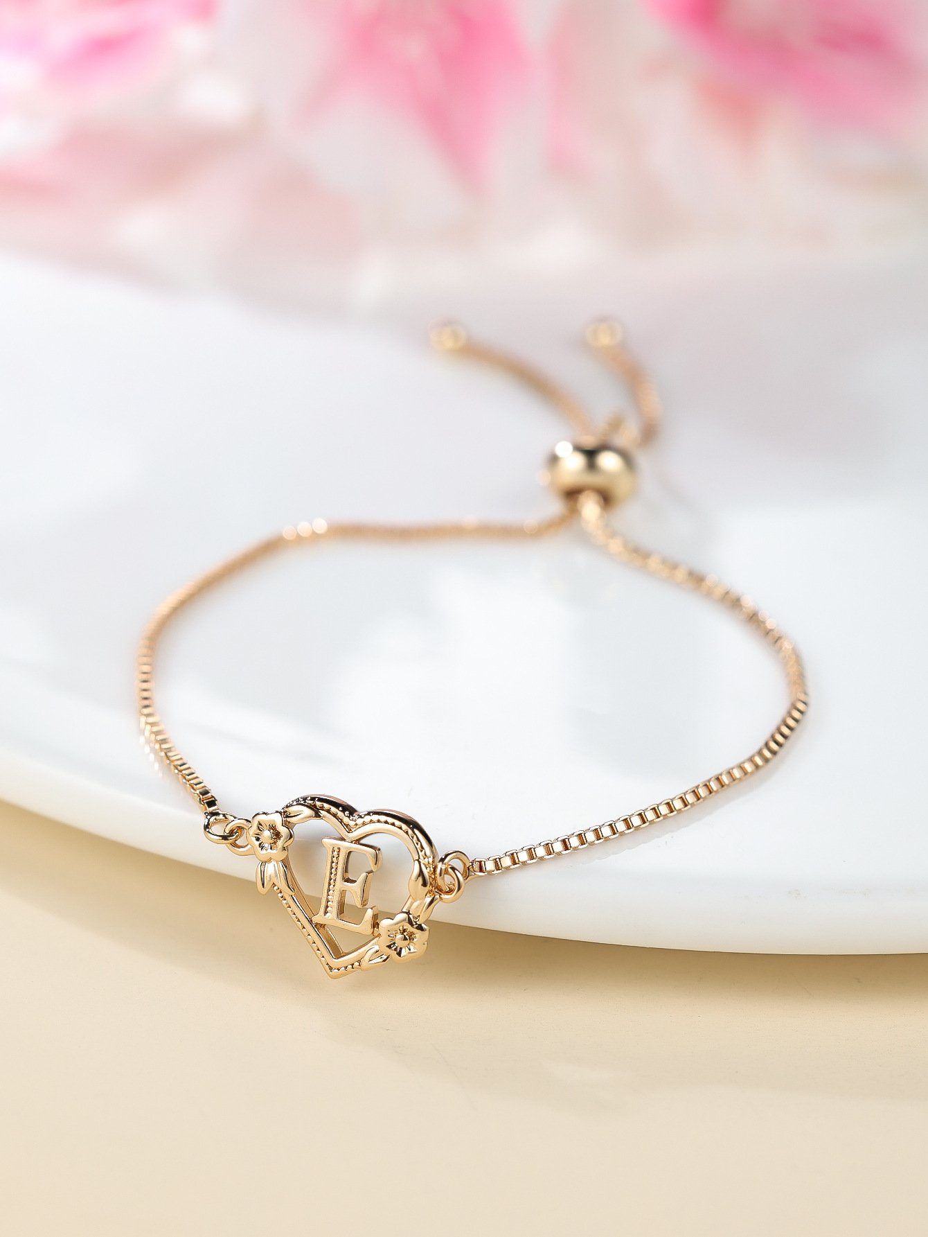 the new adjustable letter bracelet with a heart shaped flower design is a simple and fashionable jewelry the new adjustable letter bracelet with a heart shaped flower design is a simple and fashionable jewelry